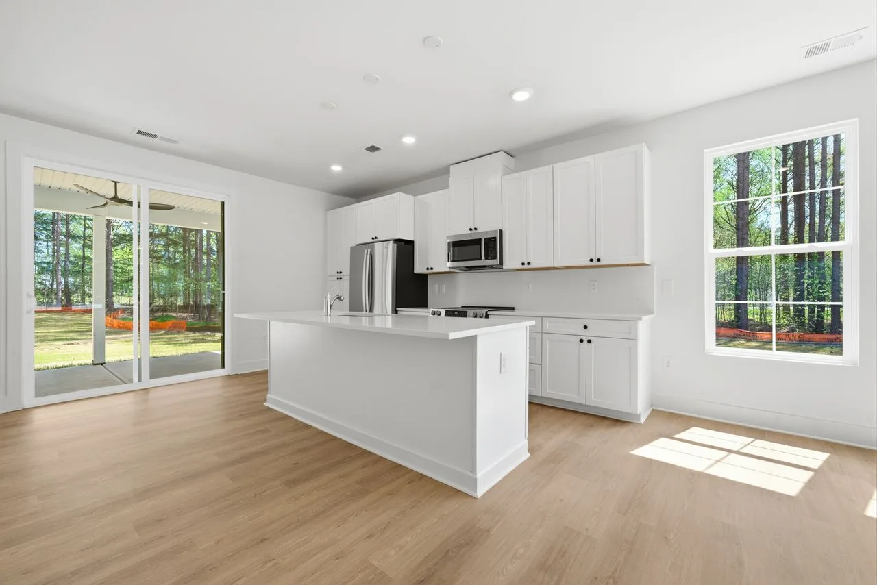 Kitchen with quartz island, shaker cabinetry, and stainless appliances — 1412 Quiver Way, York SC
