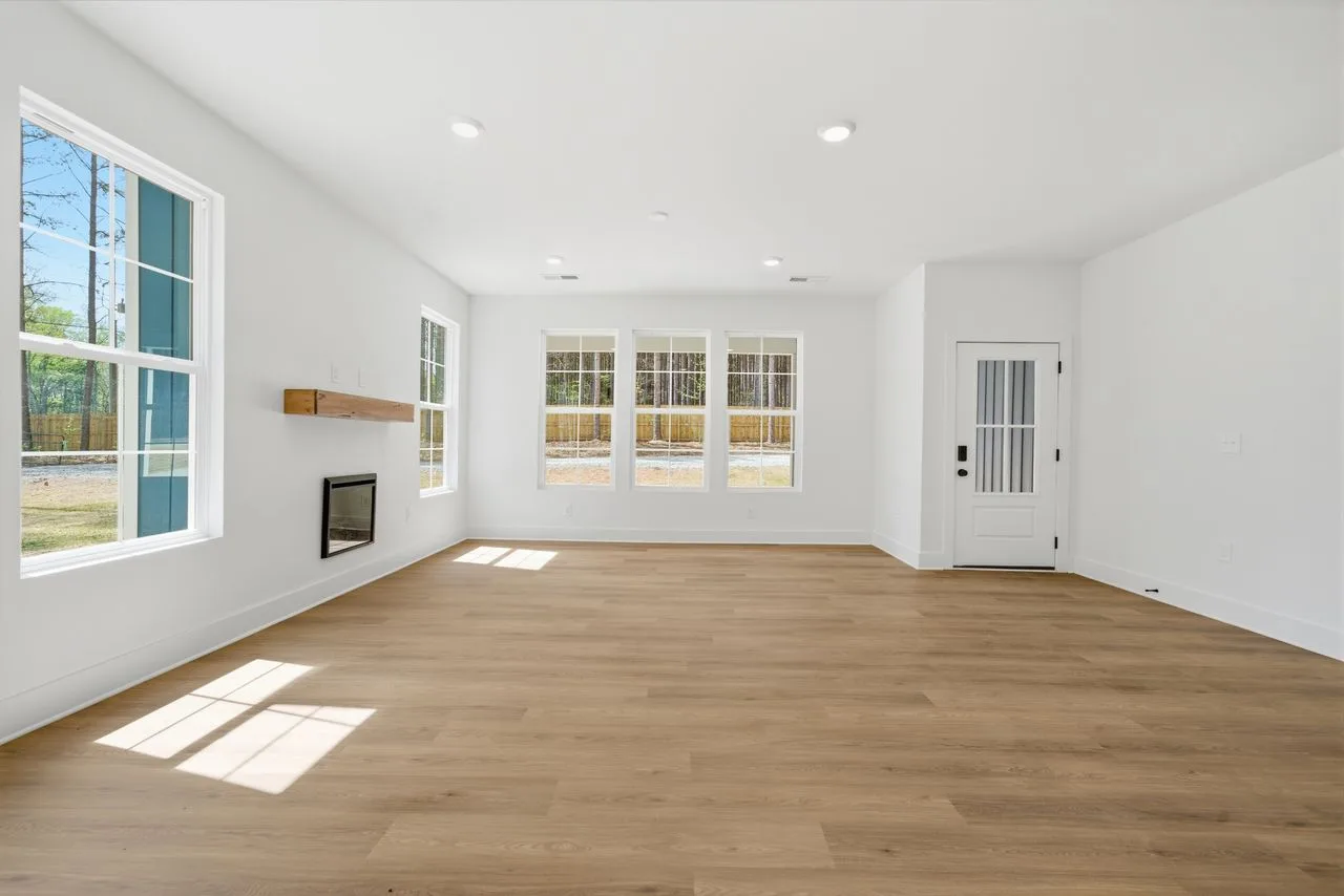 Great room with LVP flooring and wood-burning fireplace — 1412 Quiver Way, York SC