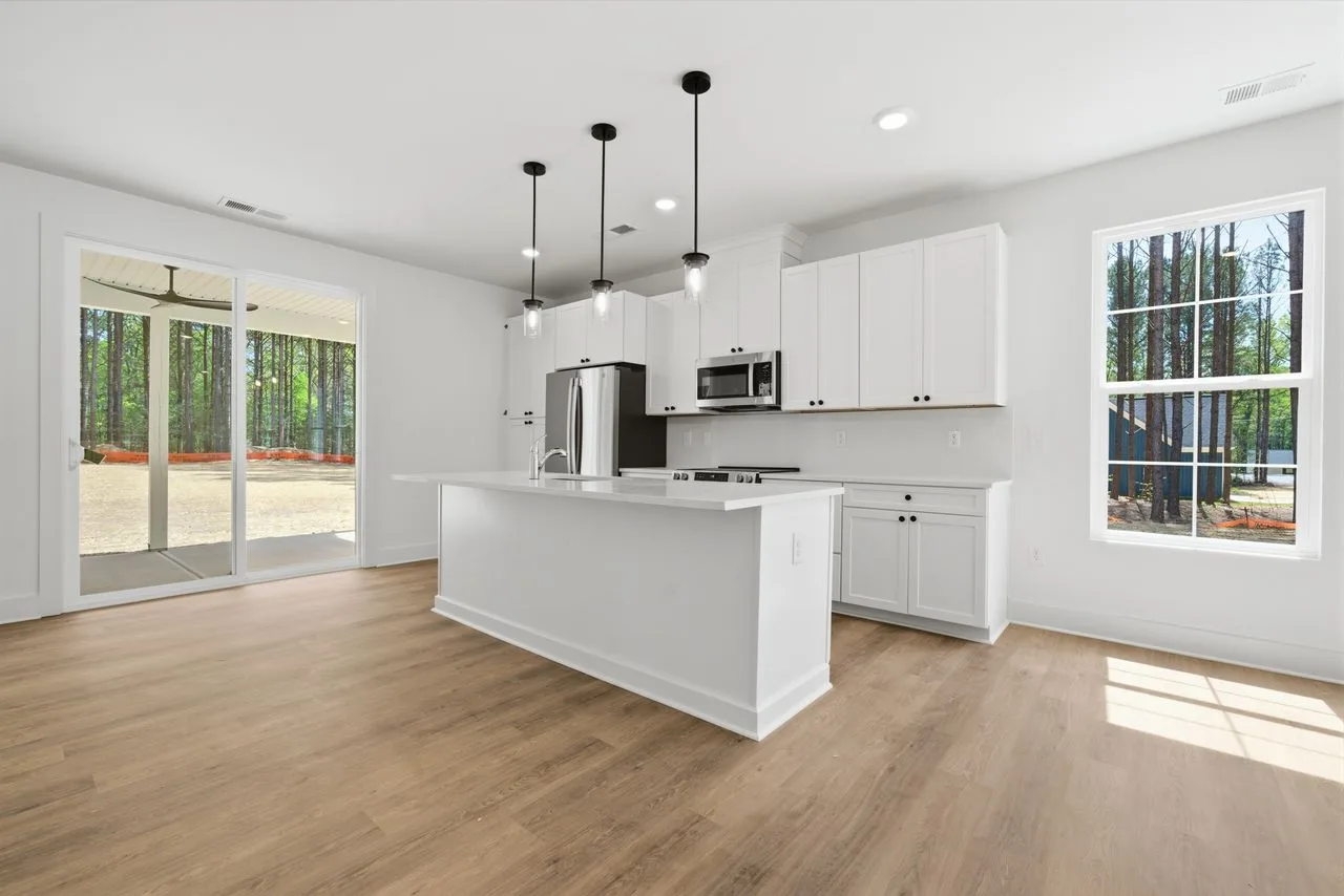 Kitchen with quartz island, shaker cabinetry, and stainless appliances — 1424 Quiver Way, York SC
