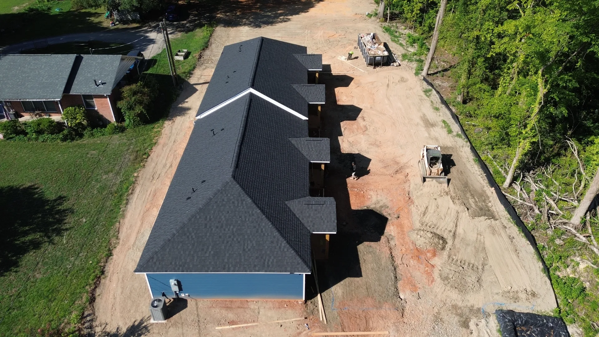 Aerial rear elevation of Clover SC quadplex showing off-street parking and site