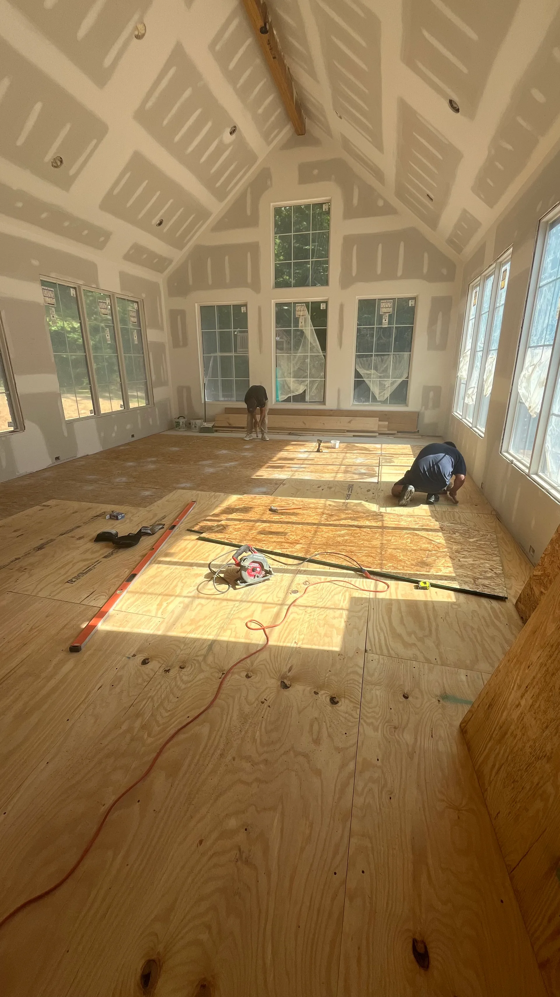 Vaulted great room interior during drywall and subfloor installation — York County SC addition