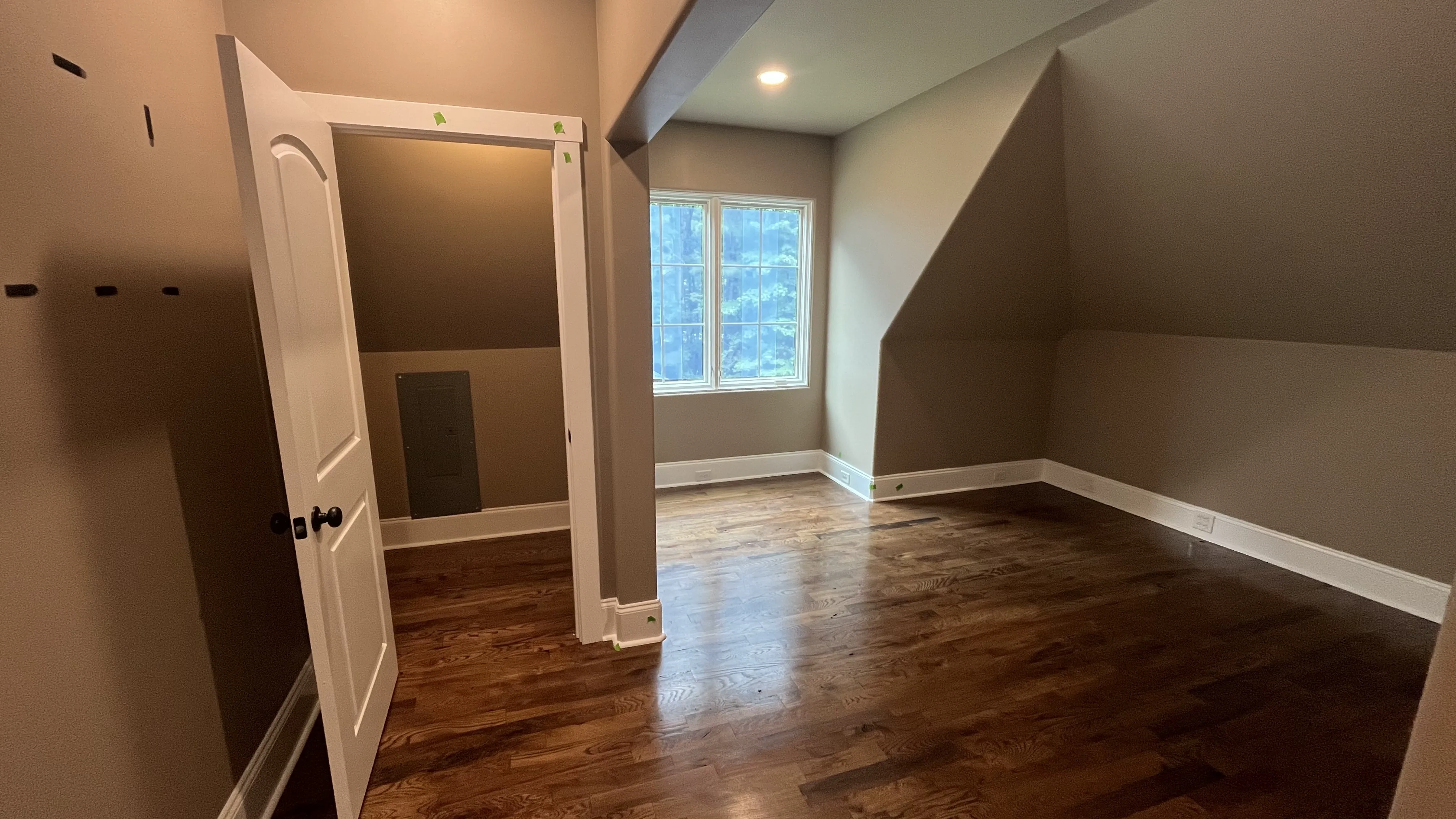 Second upper-level bedroom with hardwood floors and dormer window — York County SC home expansion