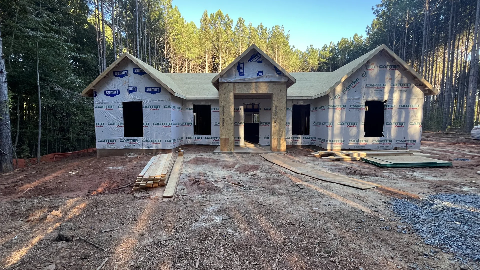 Front entry and gabled roof framing of the Contemporary Ranch with housewrap installed — York County, SC