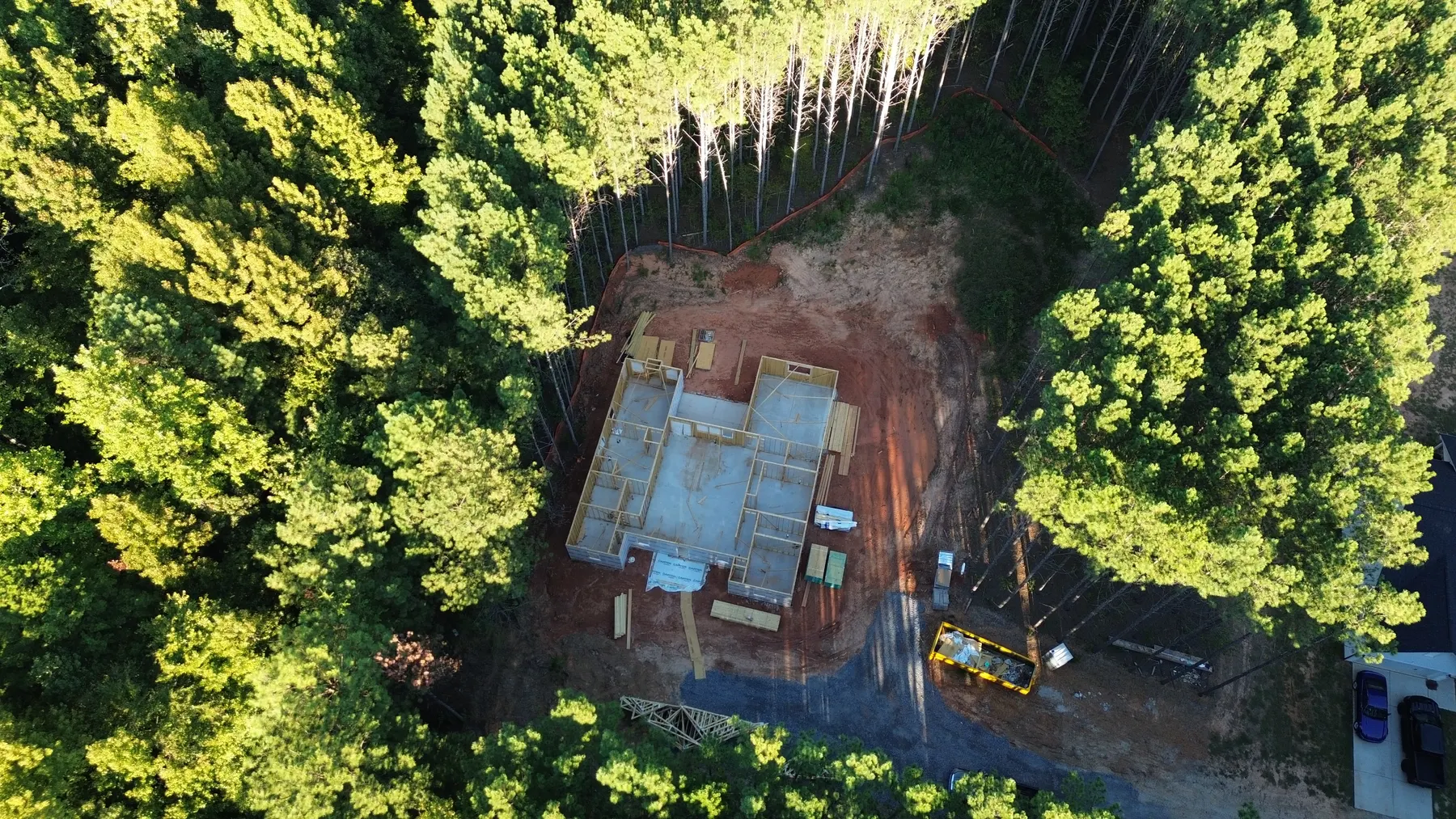 High aerial view of the Contemporary Ranch framing and surrounding wooded lot in York County, SC