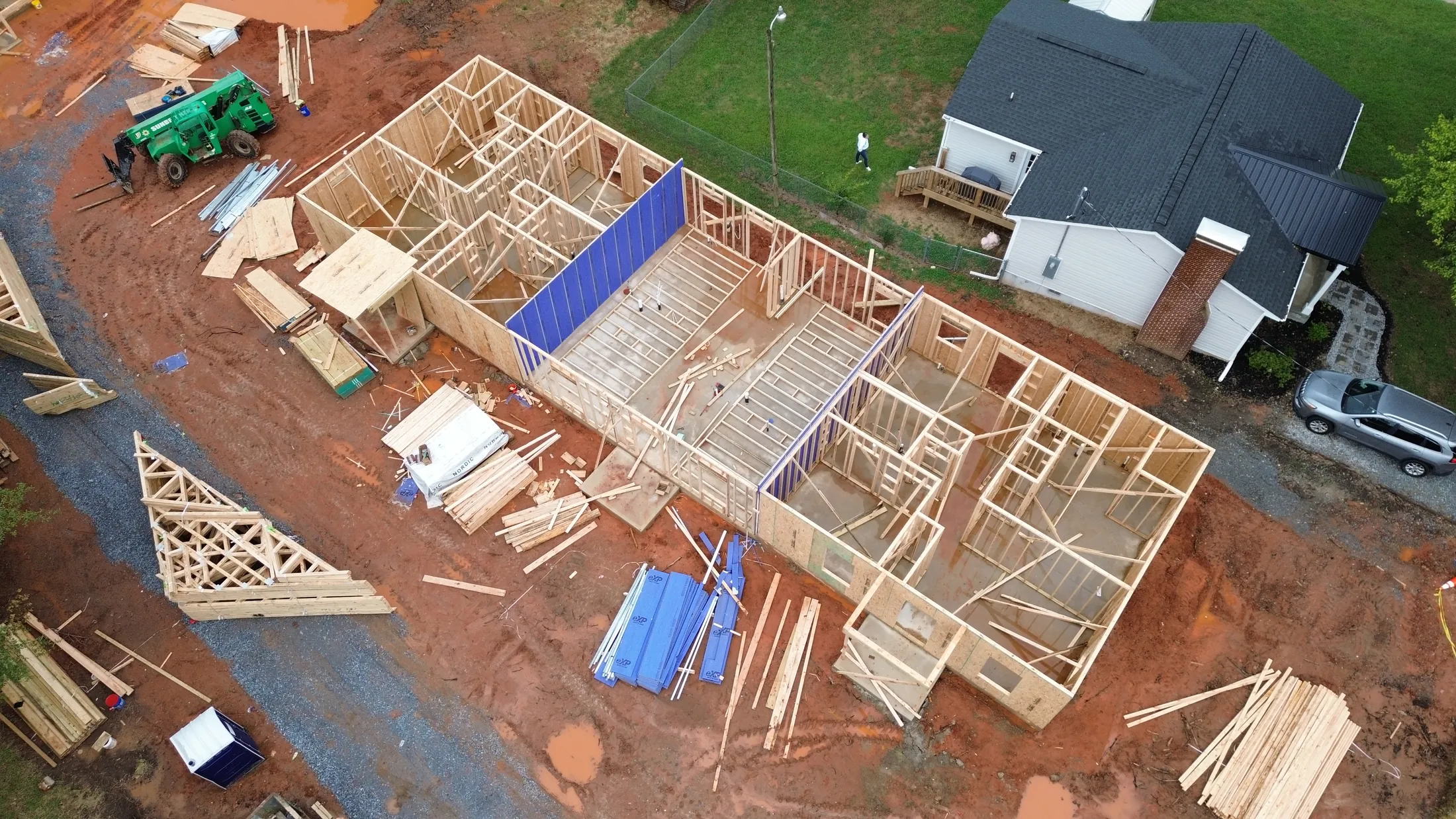 Angled aerial view of wall framing and slab foundations at the Clover, SC triplex